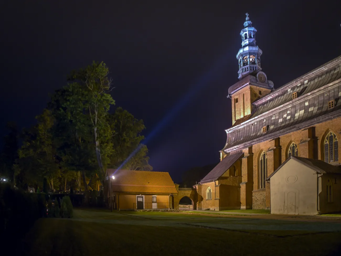 [Dla niewidomych: zdjęcie przedstawia widok kartuskiej Kolegiaty nocą]